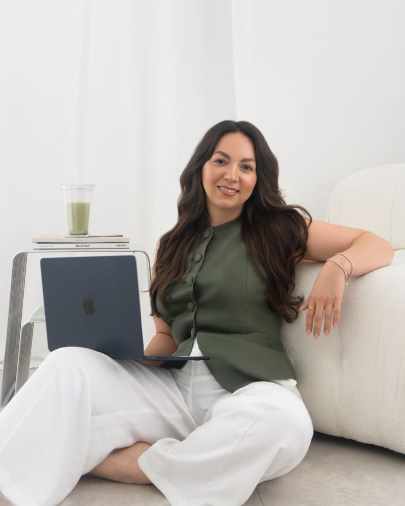 Sara Centonze sitzt mit Laptop auf einem Sofa und arbeitet an Social Media Strategien für Friseure und Beautydienstleister